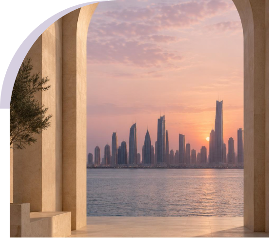 A stone archway framing a city skyline across the water at sunset